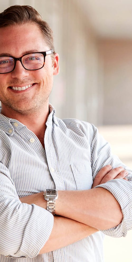 portrait-of-smiling-male-school-teacher-standing-i-7KLZDMS.jpg